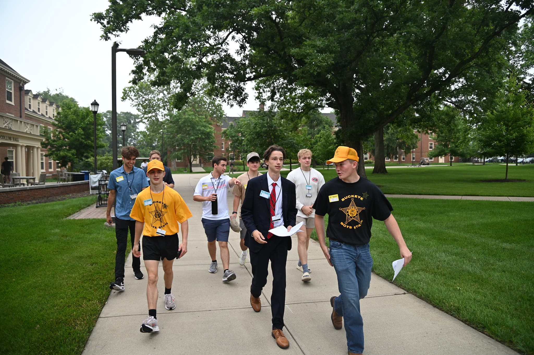 A group of several students walking and talking in a group outside at Miami University